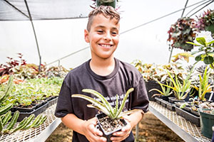 4-H-er in greenhouse